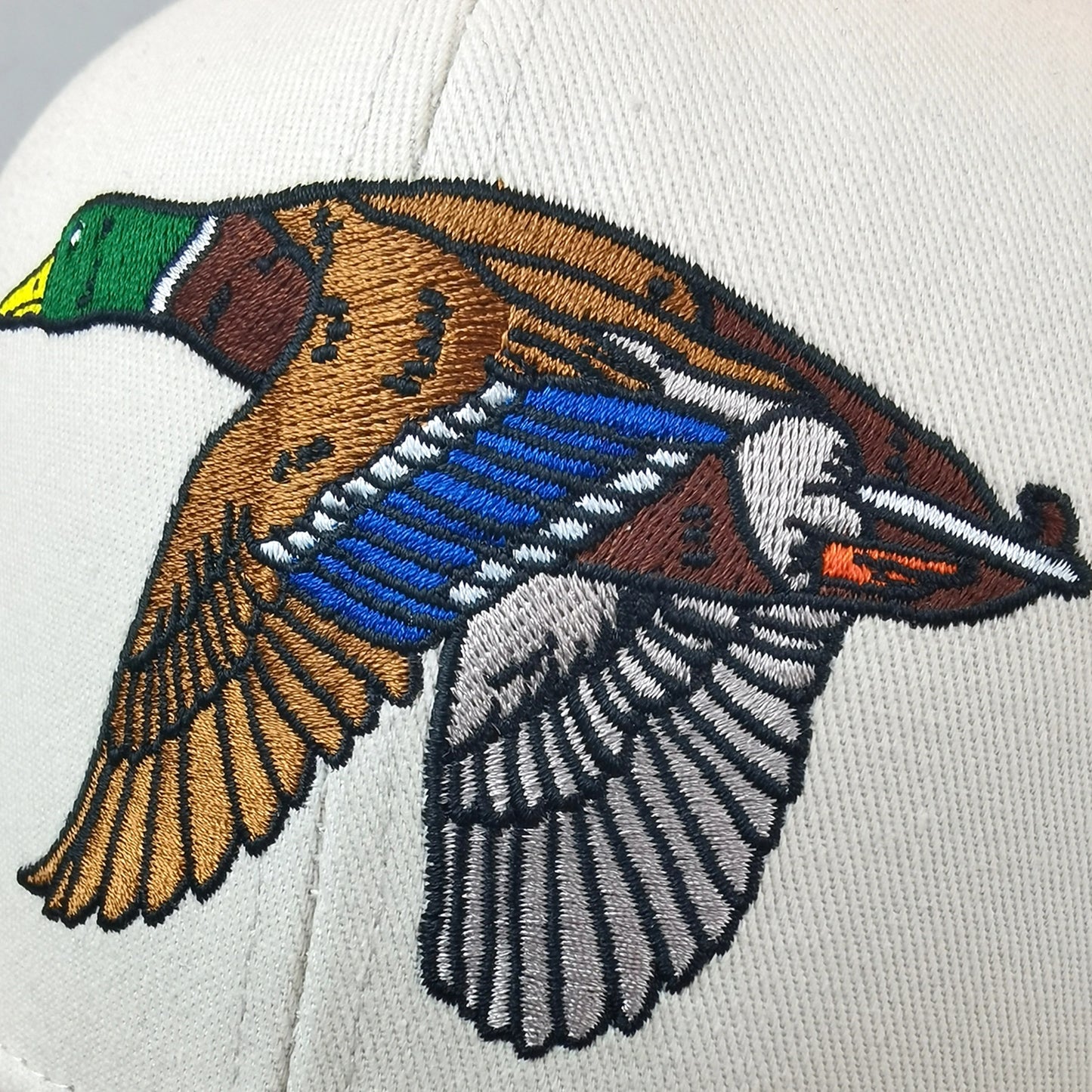Embroidered duck design on a white background